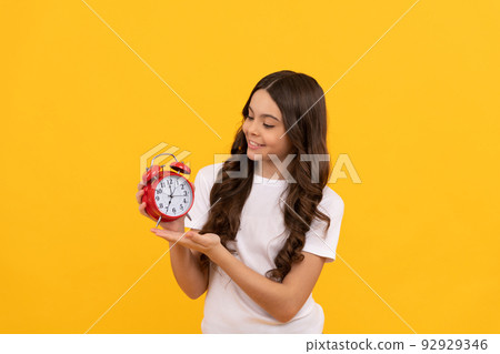 cheerful teen girl look at alarm clock. last chance. time for shopping sales. good morning. 92929346