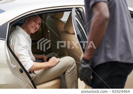 Businessman Talking to Taxi Driver Businessman Talking to Taxi Driver 92929464