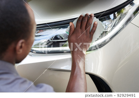 Car Owner Wiping Headlights Car Owner Wiping Headlights 92929491