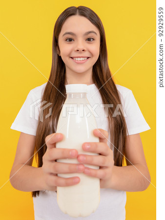 milk bottle in hand of cheerful child. kid hold dairy beverage product. 92929559