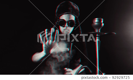 bearded man smokes a shisha in a hookah bar and blows a cloud of smoke bearded man smokes a shisha in a hookah bar and blows a cloud of smoke 92929725