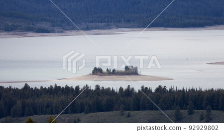 Lake surrounded by Trees and Mountains in American Landscape. Spring Season. Jackson Lake, Grand Teton National Park. Wyoming, United States. Nature Background. Lake surrounded by Trees and Mountains in American Landscape. Spring Season. Jackson Lake, Grand Teton National Park. Wyoming, United States. Nature Background. 92929802