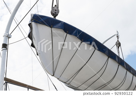 A rescue boat is on a passenger ferry above white sky 92930122