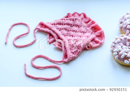Pink cap for a young child. Clothing in the first days of the child's life 92930151