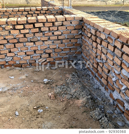 Close up view of a brick structure of a house foundation under construction 92930368