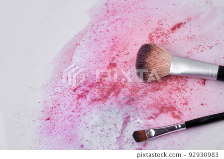 Makeup brush and scattered face powder on white background. Space for text. Makeup brush and scattered face powder on white background. Space for text. 92930983