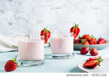 Milk smoothie with strawberries and mint in glasses on the table. Healthy homemade food 92931138