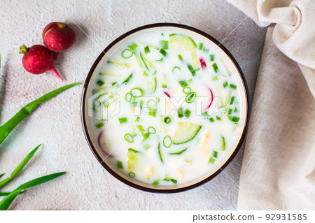 Appetizing traditional Russian cold soup with vegetables and kefir in a bowl. Top view 92931585