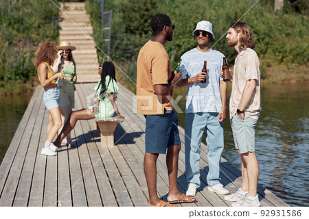 Diverse Group of Friends by Water in Summer 92931586