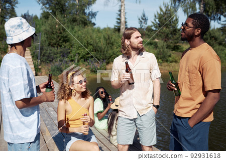 Diverse Group of Young People with Beer Outdoors 92931618