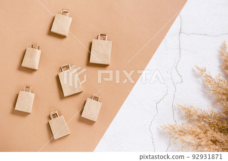 Craft paper shopping bags on a two-tone background. Sustainable lifestyle. Top view. 92931871