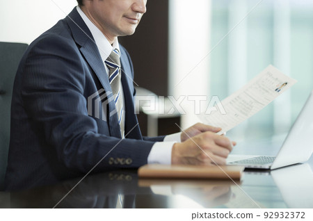 businessman looking at resume 92932372