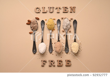 Gluten free text and spoons of various gluten free flour. Flat lay, top. 92932777