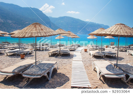 Landscape of beautiful coastline in Oludeniz with straw umbrellas. 92933064