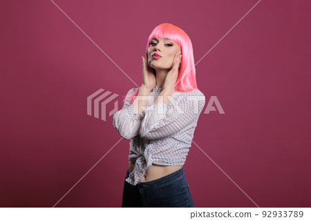 Portrait of sensual woman with sexy makeup look and trendy style, feeling confident and attractive in front of studio camera. Glamour fashion icon with pink hairstyle and beautiful face. 92933789