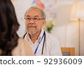 Senior Asian physician Watch as female patients discuss their health issues as you sit. 92936009
