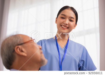 Happiness Cheerful elderly men talking with female caregiver nurse doctor having health checking consult at home. Happiness Cheerful elderly men talking with female caregiver nurse doctor having health checking consult at home. 92936011