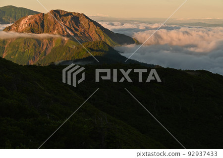 Yakedake floating in a sea of clouds in the Northern Alps in summer, seen from the ridgeline of Nishihotakadake in August Yakedake floating in a sea of clouds in the Northern Alps in summer, seen from the ridgeline of Nishihotakadake in August 92937433
