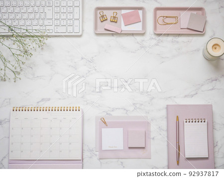 Desk frame image with pink stationery arranged on a marble desk 92937817