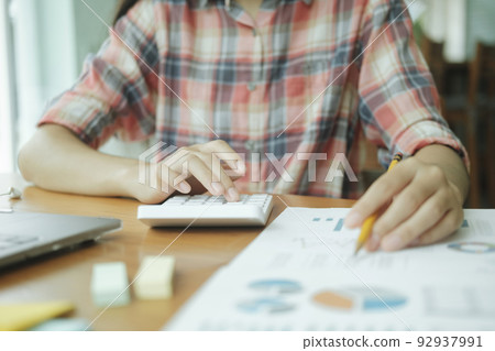 Close up young asian businesswoman analyse investment marketing data. 92937991