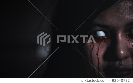 Close up of horror bloodthirsty ghost female with fade drop out from eyes 92940722