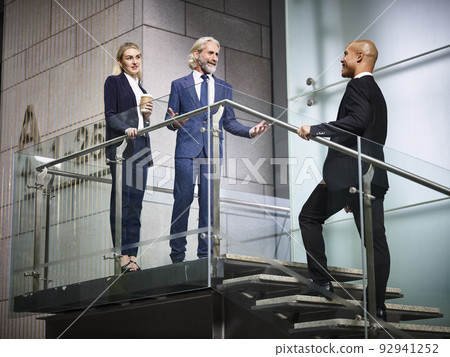 business man and woman welcoming visiting customer business man and woman welcoming visiting customer 92941252