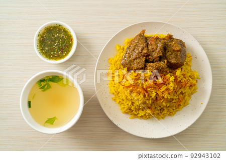 Beef Biryani or Curried rice and beef - Thai-Muslim version of Indian biryani, with fragrant yellow rice and beef 92943102