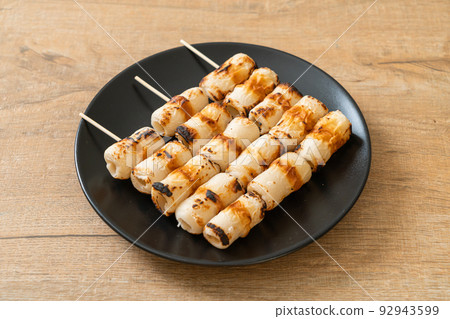grilled tube shaped fish paste cake skewe or tube squid skewer 92943599