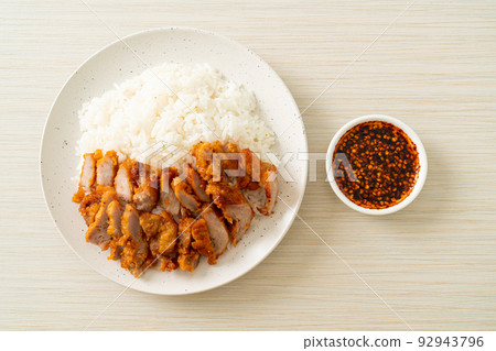 fried pork topped rice with dipping sauce 92943796