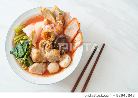 noodles with meatballs in pink soup 92943848