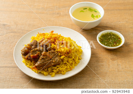 Beef Biryani or Curried rice and beef - Thai-Muslim version of Indian biryani, with fragrant yellow rice and beef Beef Biryani or Curried rice and beef - Thai-Muslim version of Indian biryani, with fragrant yellow rice and beef 92943948