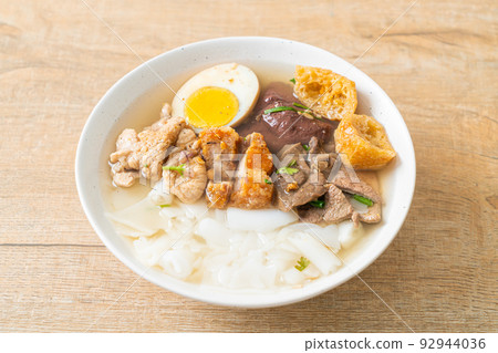 paste of rice flour or boiled Chinese pasta square in clear soup paste of rice flour or boiled Chinese pasta square in clear soup 92944036