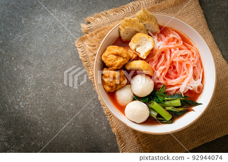 small flat rice noodles with fish balls and shrimp balls in pink soup, Yen Ta Four or Yen Ta Fo 92944074