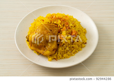 Chicken Biryani or Curried rice and chicken - Thai-Muslim version of Indian biryani, with fragrant yellow rice and chicken Chicken Biryani or Curried rice and chicken - Thai-Muslim version of Indian biryani, with fragrant yellow rice and chicken 92944286