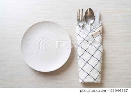 empty plate or dish with knife, fork and spoon empty plate or dish with knife, fork and spoon 92944587