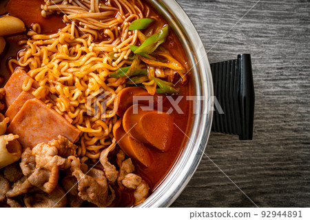 Budae Jjigae or Budaejjigae (Army stew or Army base stew). It is loaded with Kimchi, spam, sausages, ramen noodles and much more 92944891