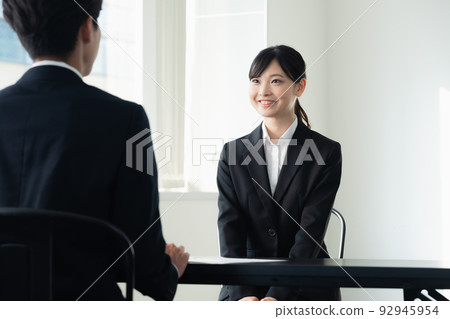 Female college student receiving an interview Female college student receiving an interview 92945954