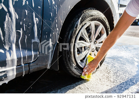 A man washes his car with foam at a - Stock Photo [92947131] - PIXTA