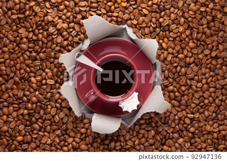 Cup of coffee and beans on paper background. Relax coffee concept Cup of coffee and beans on paper background. Relax coffee concept 92947136