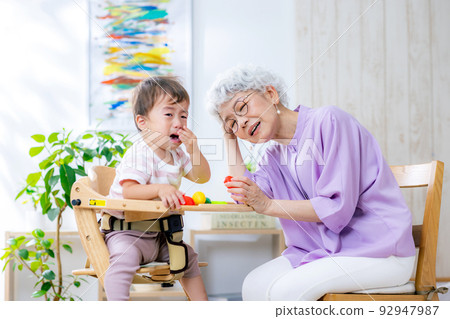 Crying toddler and tired grandma Crying toddler and tired grandma 92947987