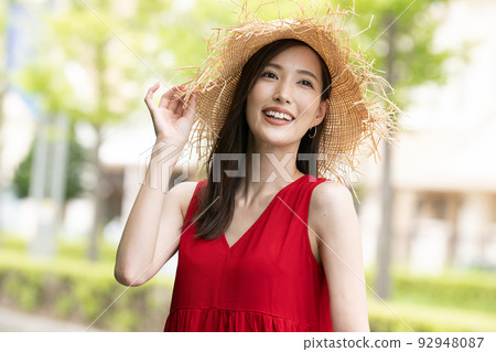 One young woman in a dress enjoying a girls' trip/resort trip 92948087