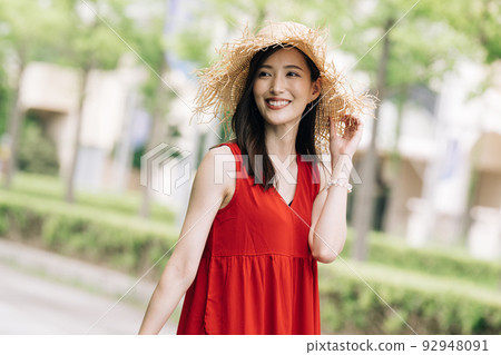 One young woman in a dress enjoying a girls' trip/resort trip 92948091