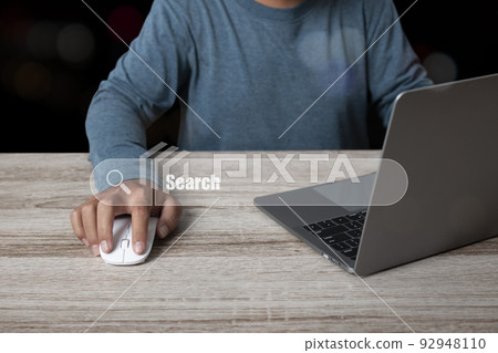 Man working with computer laptop searching browsing internet data information 92948110