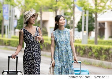 Two young women in dresses enjoying a girls' trip/resort trip Two young women in dresses enjoying a girls' trip/resort trip 92948482