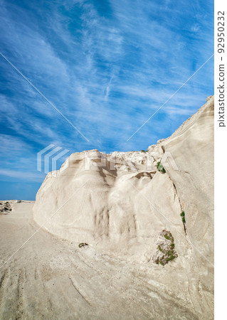 White rocks of Sarakiniko beach, Aegean sea, Milos island , Greece. No people, empty cliffs, summer sunshine, lunar landscape, deep blue sky, clouds 92950232