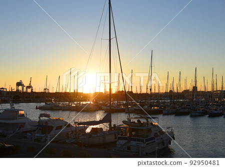 Yachts and boats in silhouette of sunset in Marina. Sunset at port. Yachts and boats in silhouette of sunset in Marina. Sunset at port. 92950481