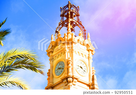 Clock tower building. Large clock tower with hour hands that shows time. 92950551