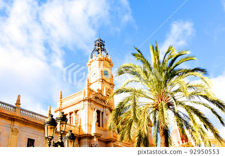 Clock tower building. Large clock tower with hour hands that shows time. 92950553