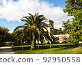 City park with green trees and palm trees. Valencia Central Park with gardens and green trees. 92950558