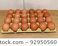 Chicken egg in box. Natural organic eggs in cardboard package on table in kitchen. 92950560